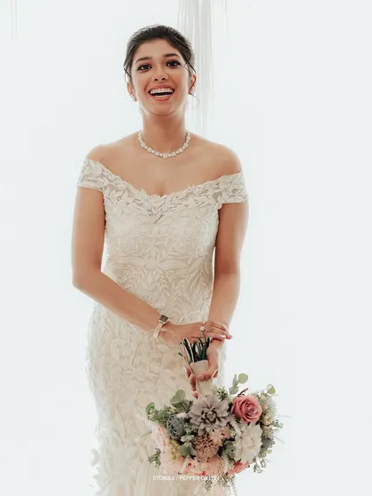 A joyful and radiant portrait of the bride, her happiness evident in her bright smile.
