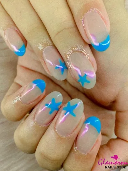 A fun and graphic design featuring bright blue French tips and matching blue stars on the accent nails, all on a natural, sheer base.