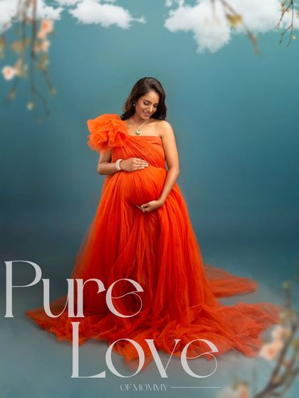 This solo portrait in a brilliant orange-red gown is titled "Pure Love." It captures a quiet moment of connection between the mother and her unborn baby, full of warmth and affection.