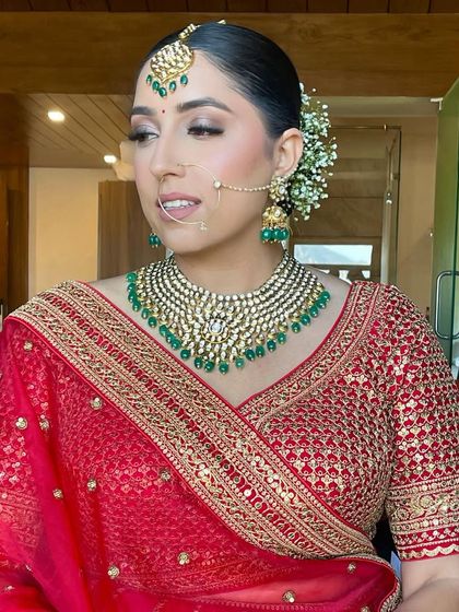 A side view of the bride, showing her elegant updo and beautiful jewelry.