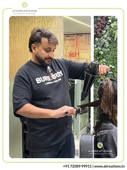 Creative Art Director Alam is focused on perfecting a blowout, a crucial step to showcase the movement and texture of a new haircut.