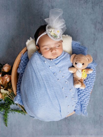 Cuddled up with a tiny teddy bear in a rustic bowl. I love adding small, sweet details that add a touch of personality and charm to the classic newborn portrait.