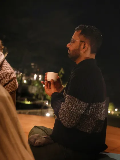 A participant holding a cup of cacao during our evening ritual. These moments of quiet reflection and shared experience are deeply nourishing for the soul.