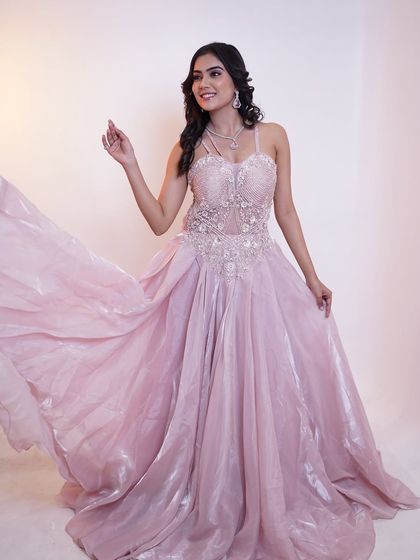 A full, flowing shot of the pink gown, looking like it's straight out of a fairytale.