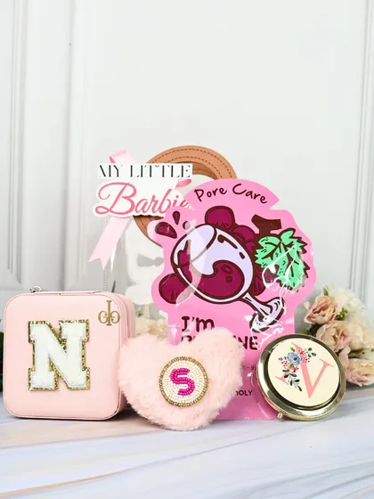 The "My Little Barbie" hamper is perfect for those who love all things pink. It includes a personalized jewelry organizer, a fluffy heart pouch, a custom pocket mirror, and a face mask.