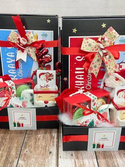 Personalized Christmas hampers for kids, complete with their names, Santa mugs, and other festive treats to make their holiday season magical.