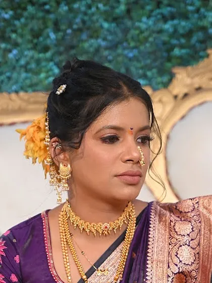 A close-up of the bride's Vidhi look in a purple saree. The makeup is soft and ethereal, with a focus on her glowing skin.