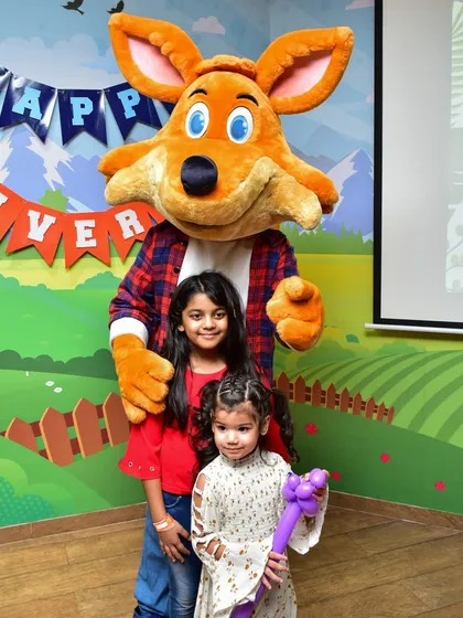 Two young guests pose with J the Fox during our anniversary celebration.