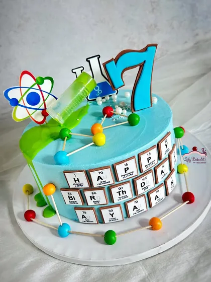Another view of the science-themed cake, showing the overflowing beaker.