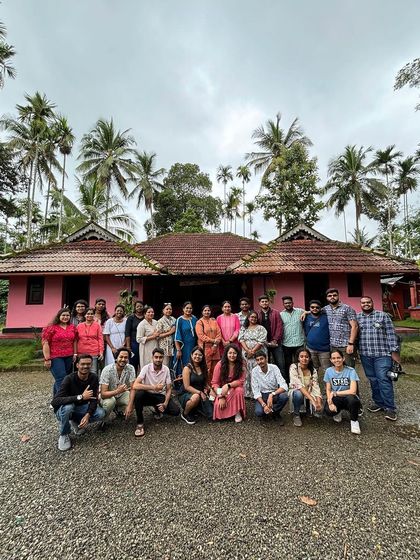 Our Wayanad group posing in front of a traditional Kerala-style homestay.