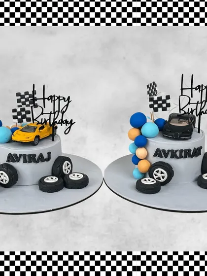 A double birthday celebration for Aviraj and Avkirat calls for twin race car cakes. Each cake is personalized with their name, a cool car, and fondant tires.