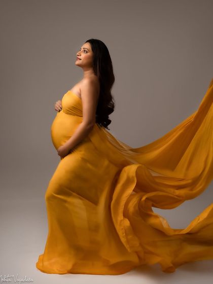 A hopeful gaze. This pose in a flowing yellow gown captures the feeling of looking forward to all the joy that is to come.