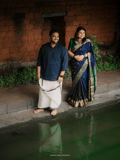 A quiet portrait by the temple pond, reflecting the couple's serene connection. This pre-wedding shoot in Kerala was about capturing love in a tranquil, traditional setting.
