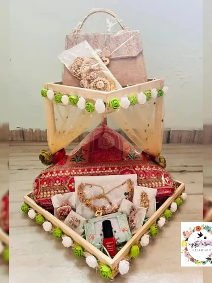 A unique 'Mandap' themed hamper for a bride. The structure mimics a wedding mandap and is used to present jewelry, clothes, and other bridal essentials beautifully.