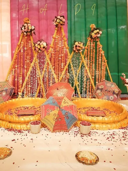 A shot of the beautiful and colorful Haldi decor before the ceremony begins. We pay attention to the details that make your event special, from the floral arrangements to the seating.