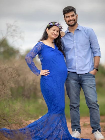 A beautiful outdoor maternity portrait. The vibrant blue lace gown stands out wonderfully against the natural scenery, and the floral crown adds a perfect touch.