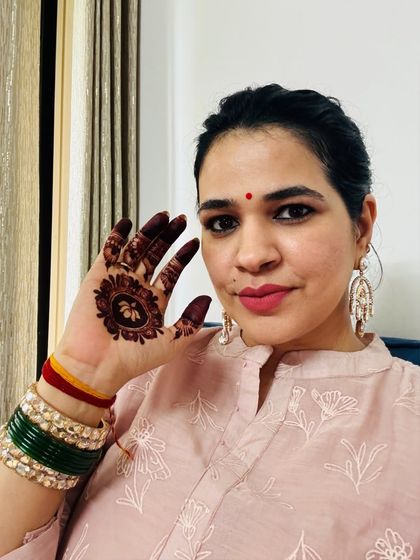 A close-up of my Hariyali Teej look. I paired my simple pink kurta with these beautiful statement earrings and of course, the traditional green bangles and a small bindi. It's the little details that make a festive look complete.