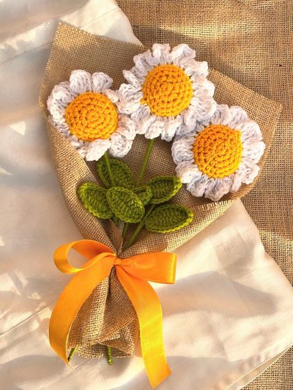 Chasing daisies and dreams. A simple and beautiful bouquet of three crochet daisies wrapped in burlap with a sunny yellow ribbon.