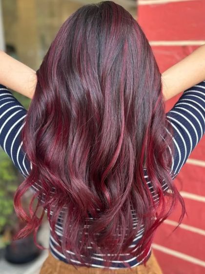Creating memories one highlight at a time. This look features a beautiful blend of dark hair with rich red highlights.