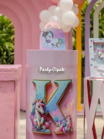 I love personalizing the decor. This setup included a custom plinth with a large initial 'K' decorated with unicorns for the birthday girl, Kaashni.