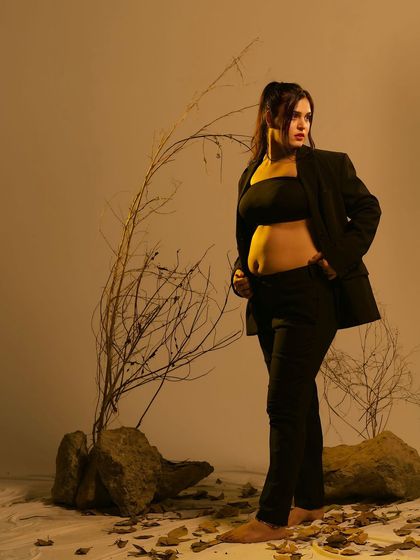 Another angle from the modern, edgy studio shoot, this portrait captures a look of confidence and strength, blending contemporary fashion with maternity photography.