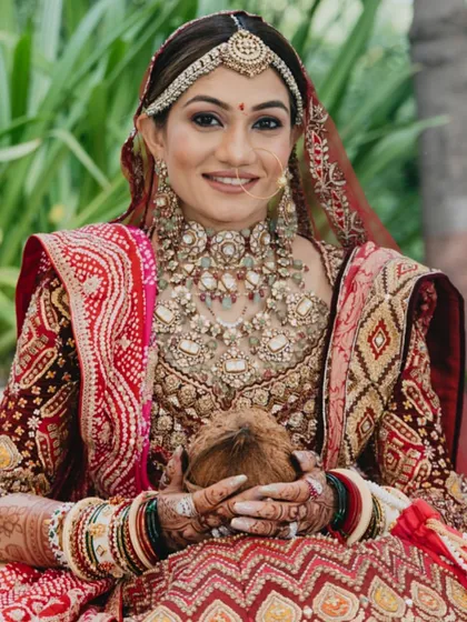 A portrait of the beautiful bride holding the sacred coconut, an essential part of many Indian wedding rituals, symbolizing purity and prosperity.