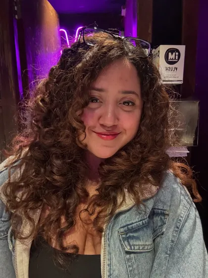 This client's testimonial photo says it all. She was thrilled with her new routine and how good her curls looked after her visit.
