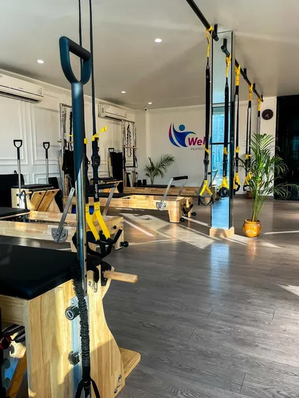 Sunlight streams into our studio, highlighting the pristine equipment and positive ambiance. We combine TRX suspension trainers and Reformers to offer a diverse and effective fitness experience.