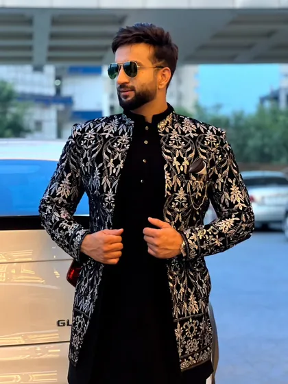 A close-up of the black and silver brocade jacket, showing the intricate pattern and the perfect fit.