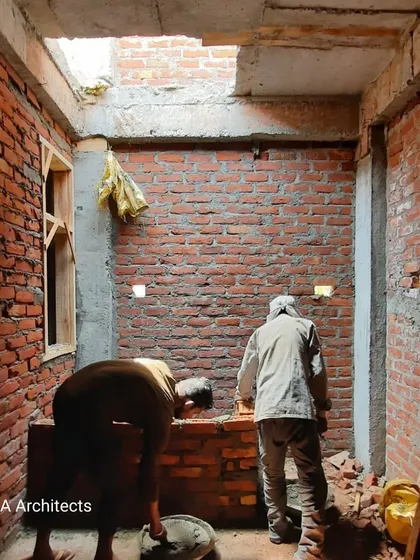 A view from an active construction site, showing the initial stages of brickwork for an interior space. This foundational work is critical, and our team ensures that every wall is built with precision to support the complex layers of finishing that will follow.