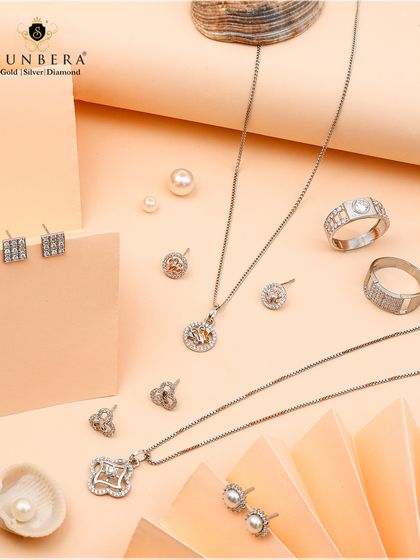 Embrace timeless elegance with this exquisite assortment of silver jewellery, including delicate necklaces, rings, and pearl earrings, all showcasing pure craftsmanship.