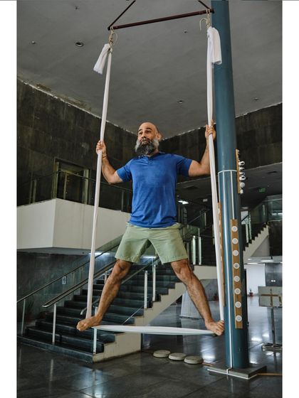 Our instructor demonstrates a standing pose using the hammock, showing how it can be used for more than just inversions.