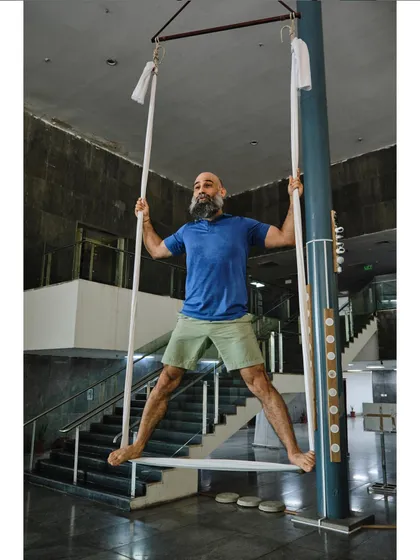 Our instructor demonstrates a standing pose using the hammock, showing how it can be used for more than just inversions.