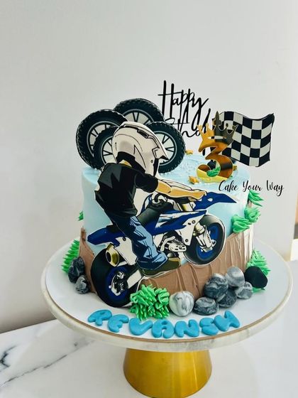 A cool dirt bike themed cake for a 3rd birthday, capturing the thrill of the race.