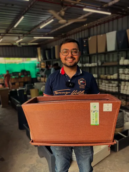 Another shot of me holding the versatile brown roto 'kishti' planter, a customer favorite for its practicality and design.