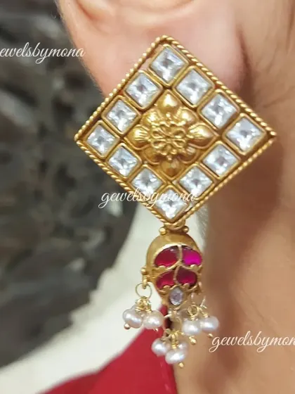 A client wearing the Dakshinaya diamond-shaped polki studs. The size and design make a beautiful statement, while the small pearl and ruby drop adds a touch of color and movement.