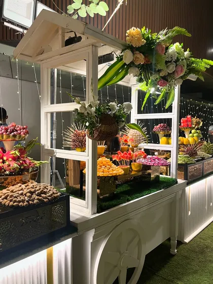 The white fruit cart is a stylish and popular addition, offering a variety of fresh and healthy options.