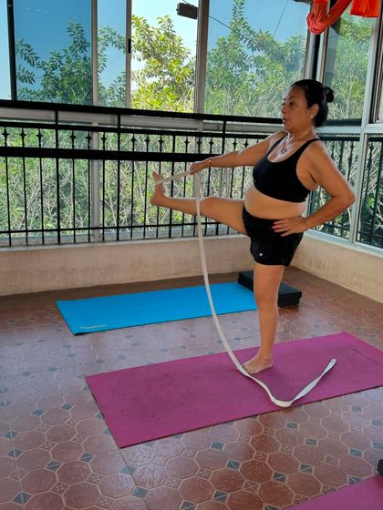 This student is using a strap to work on her leg extension and flexibility. Props are essential in my classes to help everyone explore their body's potential safely and effectively.
