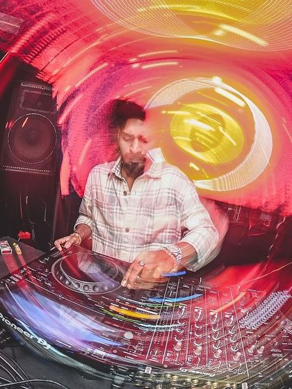 A creative shot using a slow shutter speed to capture the motion and energy of me DJing at Error.