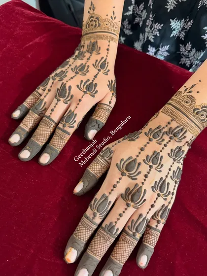 An elegant and minimal mehendi design for a baby shower. This pattern features delicate lotus chains, perfect for a chic and modern celebration.