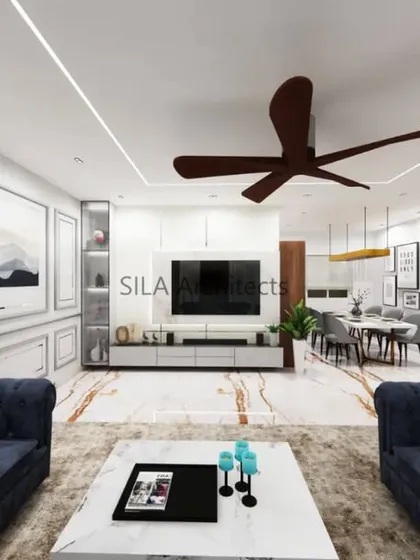 A render of a spacious living room with deep blue chesterfield sofas and a clean, minimalist TV unit. This visualization helps in selecting furniture and color schemes that reflect the client's style.
