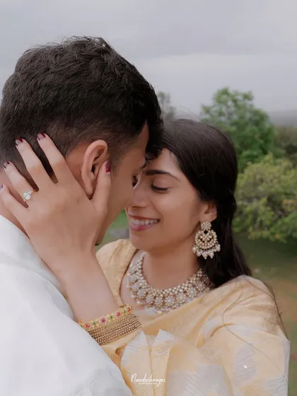 A close-up of a couple's embrace, focusing on the bride-to-be's joyful smile and the engagement ring.