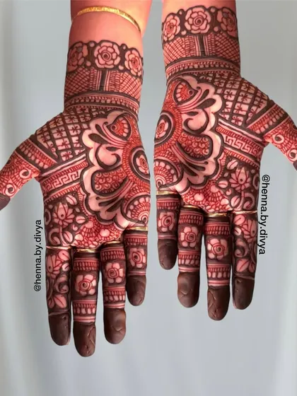 A classic Indian mehendi design with a bold central mandala. The hands are filled with a mix of floral, paisley, and geometric patterns for a full and festive look.