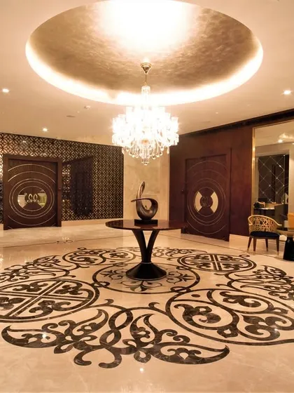 A lobby is the first impression of a building, and it needs to make a statement. In the Bellevue lobby, I used a bold, intricate marble inlay on the floor and a massive, ornate mirror to create a sense of opulence and grandeur. It’s a space designed to feel luxurious from the moment you step inside.