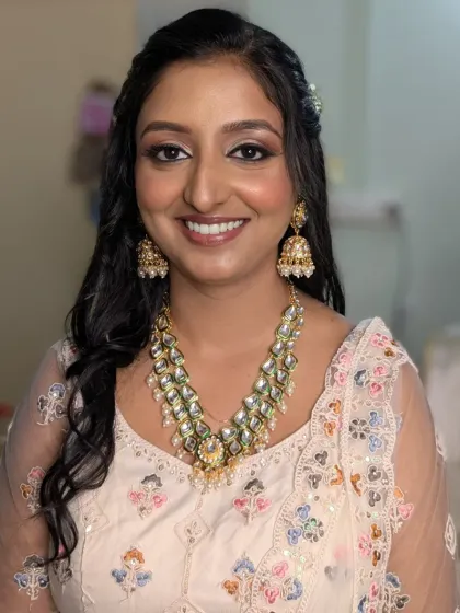 A bright, happy portrait of the bride-to-be. The soft lighting highlights her flawless makeup and the beautiful details of her Kundan necklace.