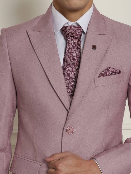 A close-up of the pastel pink suit, showing the matching paisley tie and pocket square. The details make the difference.