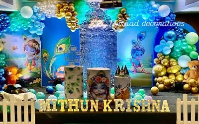 This beautiful Krishna-themed decoration is perfect for birthdays or baby showers. It features a stunning backdrop with illustrations of little Krishna, a blue sequin panel, and peacock feather details throughout.