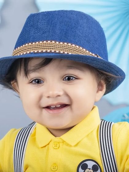 This dapper little fellow in his blue fedora and yellow shirt is ready for his close-up.