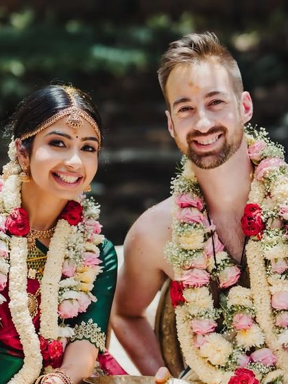 A happy portrait of a multicultural couple, their smiles radiating pure joy and love.