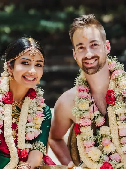 A happy, smiling portrait of a cross-cultural couple, their joy evident as they celebrate their union.